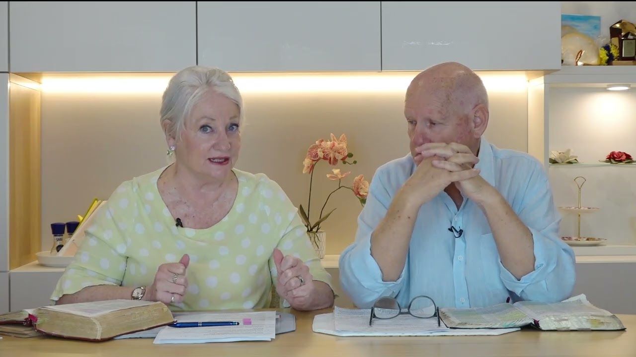 Susan Cunningham teaching as Shayne Cunningham listens, open Bibles on the table