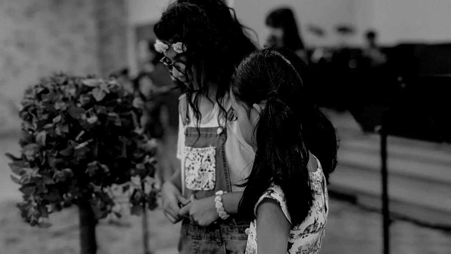 Two young girls side by side, in black and white