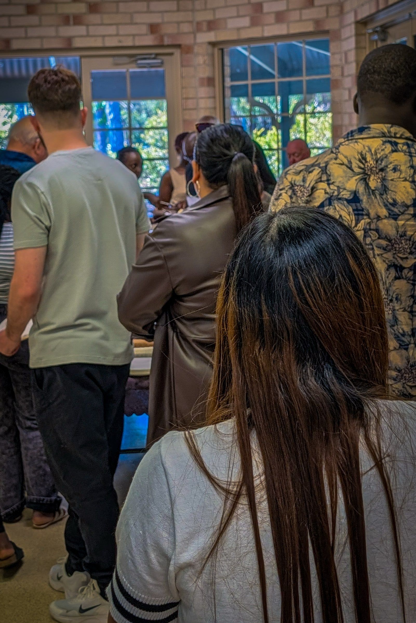 People of many backgrounds gathered together in the hall at CoastWIDE Church, Arundel