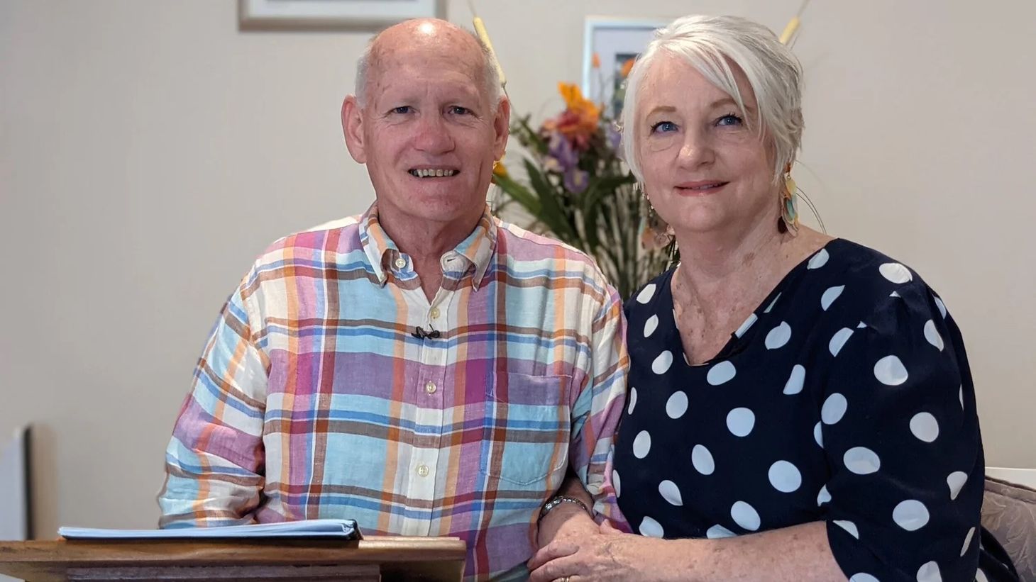 Pastors Shayne and Susan Cunningham of CoastWIDE Church, seated together and smiling